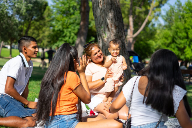 Latin multigenerational family spending a sunny day together in a park